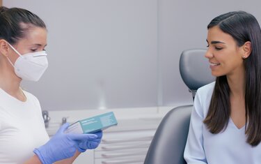 A female dentist talking to a female patient about Ivoclar's Professional Teeth Whitening product range